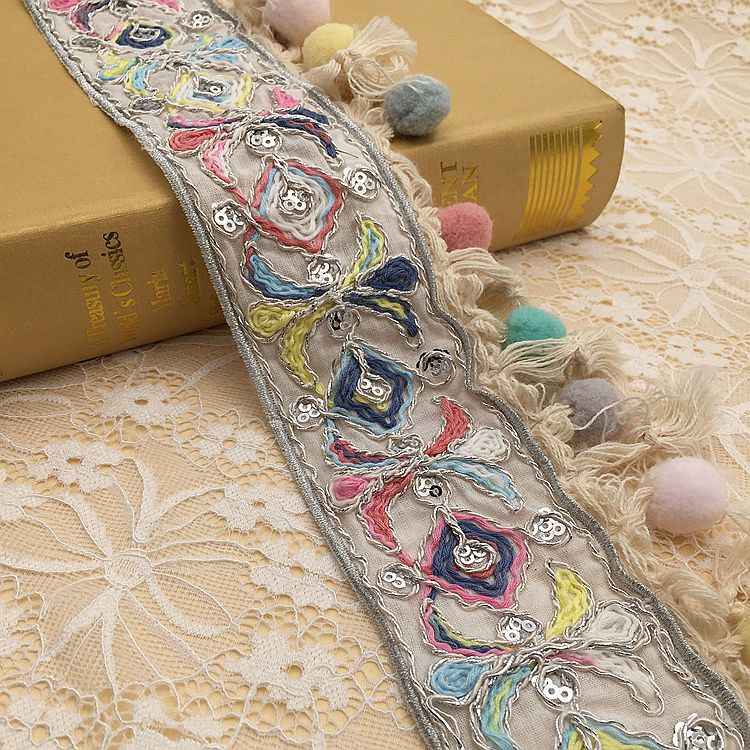 Embroidered jacquard lace trim with multicolor figure motifs and tassel fringe