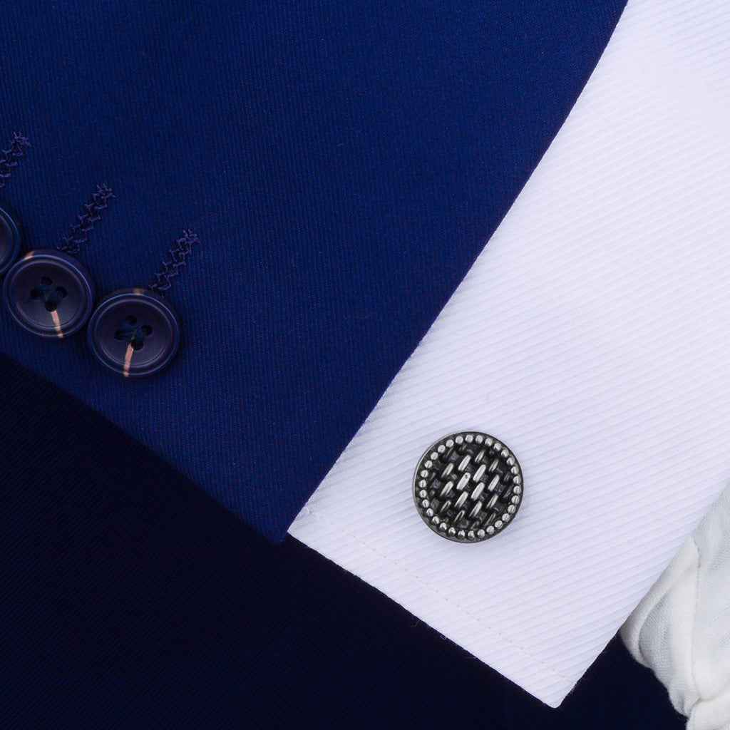 Antique silver round cufflink on shirt cuff, black inlay with bead border