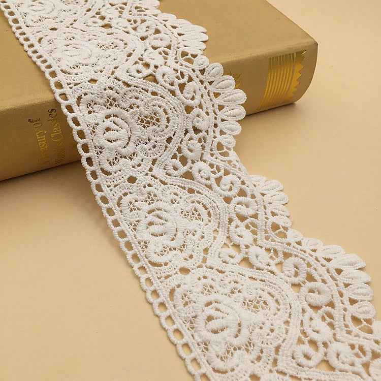 White cotton lace trim with geometric embroidered floral scroll pattern, 9.5 cm