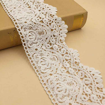 White cotton lace trim with geometric embroidered floral scroll pattern, 9.5 cm