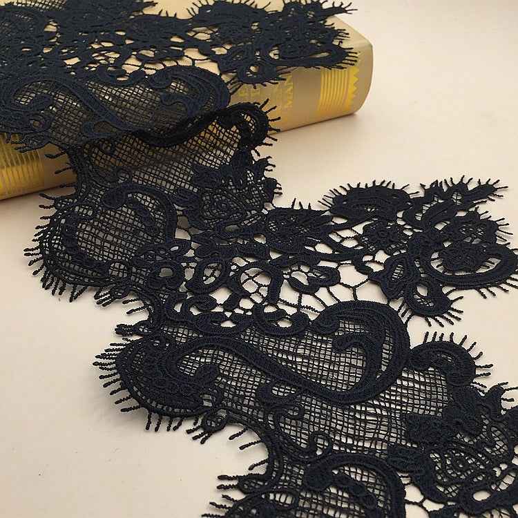 Black lace polyester trim with ornate floral motifs and scalloped fringe edge