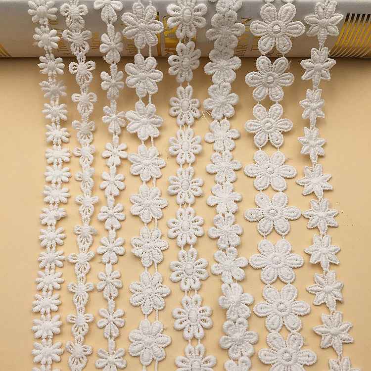 White lace trim with layered floral appliqué bands and dangling flower details