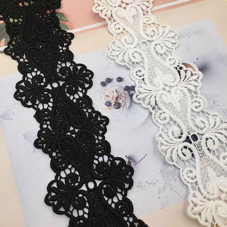 Black and white lace trim featuring ornate floral patterns with scalloped edges