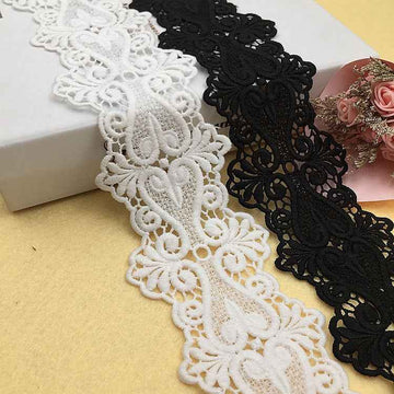 Black and white embroidered lace trim with floral scalloped motifs, water-soluble