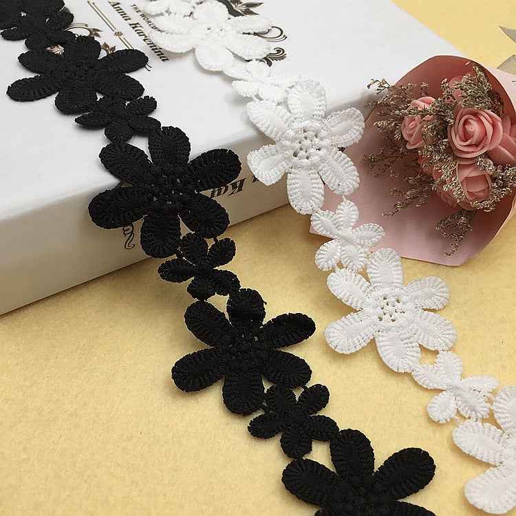 5,5 cm Spitze in Bandform mit schwarzen und weißen bestickten Blumen