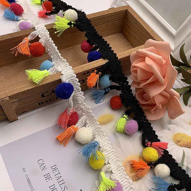 Black cotton lace trim with multicolor pom-pom tassels and scalloped border