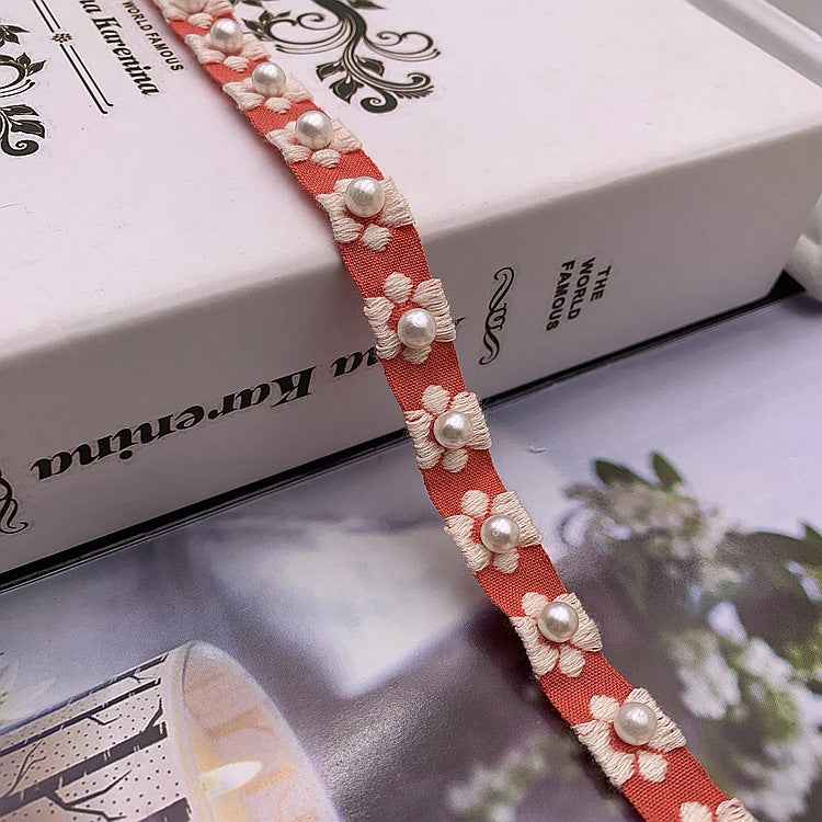 Dark pink jacquard lace trim, 1.5 cm wide, with raised floral pearls and white bead accents
