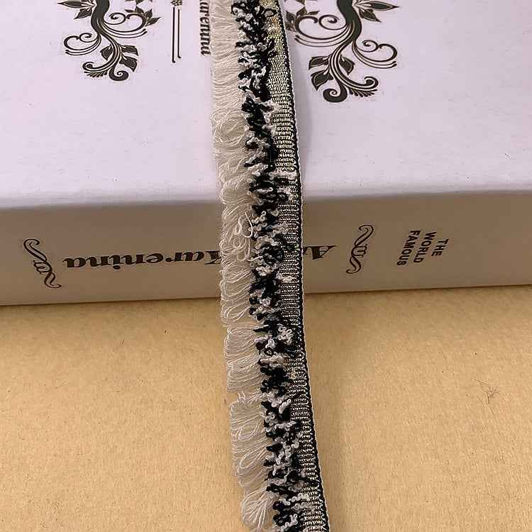 Black lace trim with white fringe along the edge