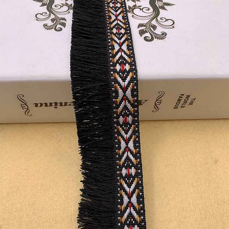 Schwarze Fransenborte mit Jacquard-Musterstreifen in rot, weiß, gold und blau