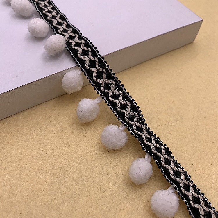 Black pom-pom trim with white braided detail and round white pom accents