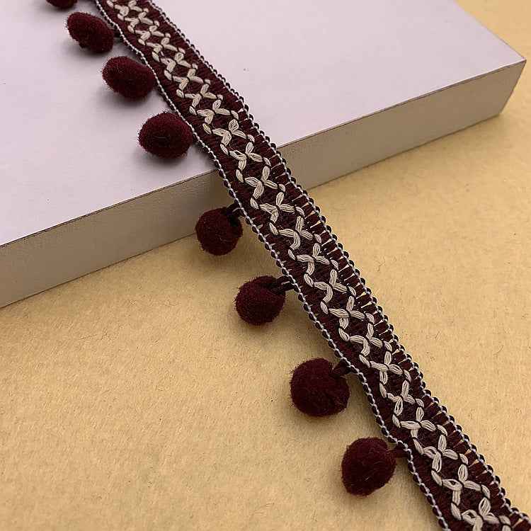 Dark red and black pom-pom trim with braided texture and small round pom poms