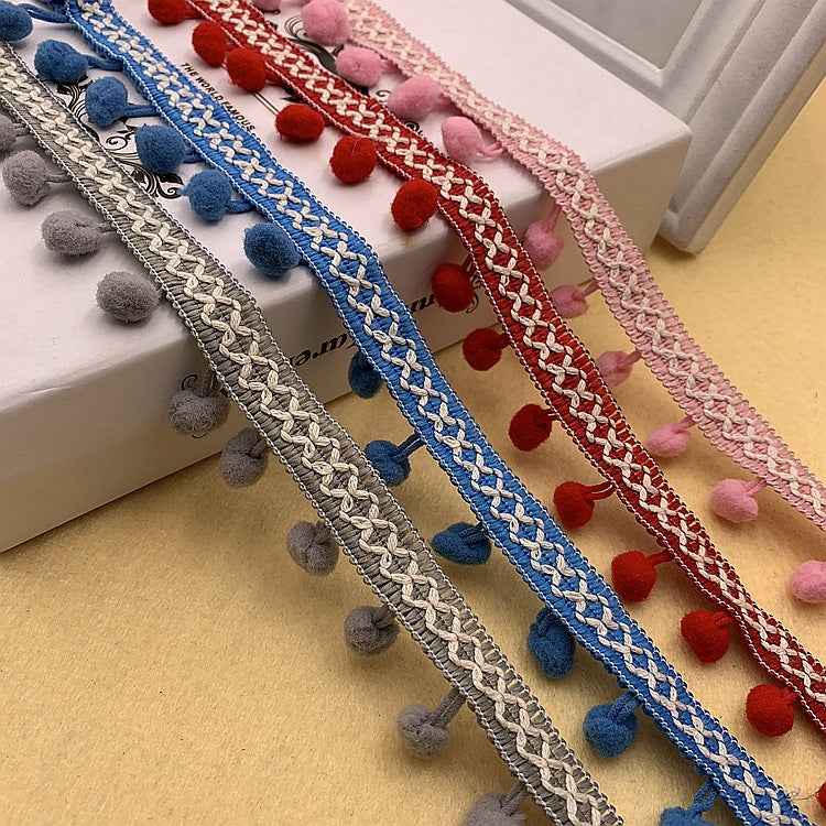 Blue, red, pink, and gray pom-pom trim with braided pattern and fuzzy round pom poms