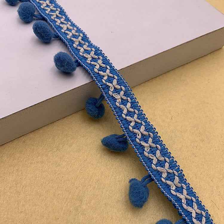 Sky-blue pom-pom trim with white braided pattern and small round pom poms