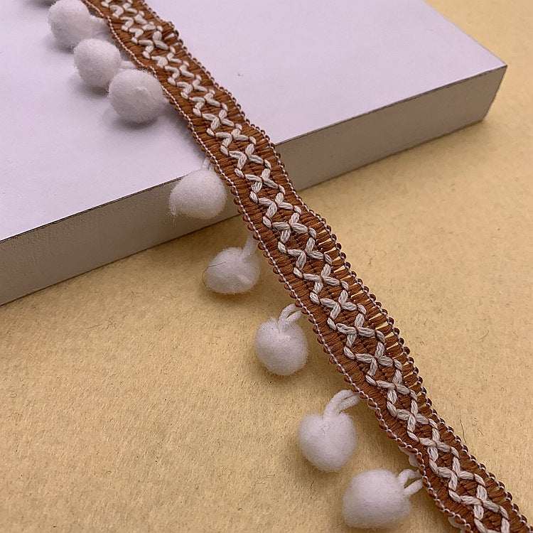 Light gray pom-pom trim with white braided detail and round pom accents