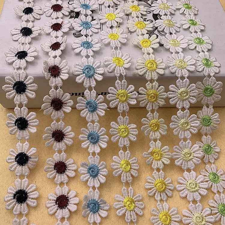 Daisy-petal lace trim, white with mixed daisy colors—yellow, green, blue, and black centers