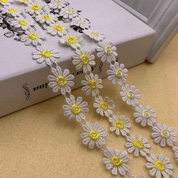 Daisy-petal lace trim, white with yellow daisy centers in a continuous floral border