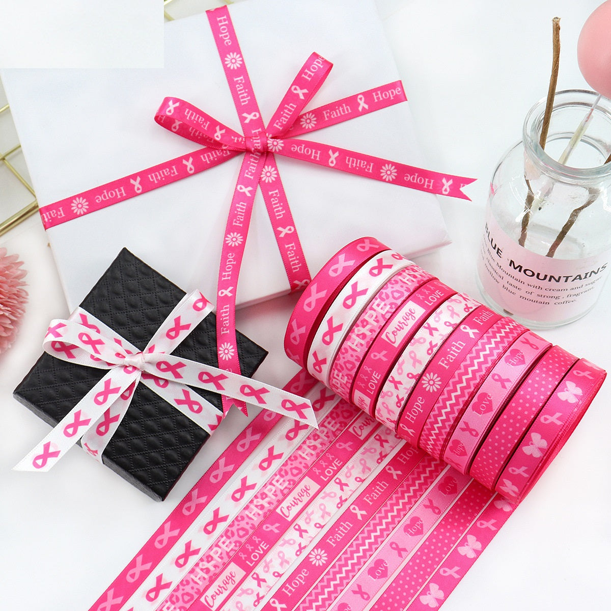 Pink 10mm ribbon spool with faith/hope/love print, plus matching ribbon tied on black.