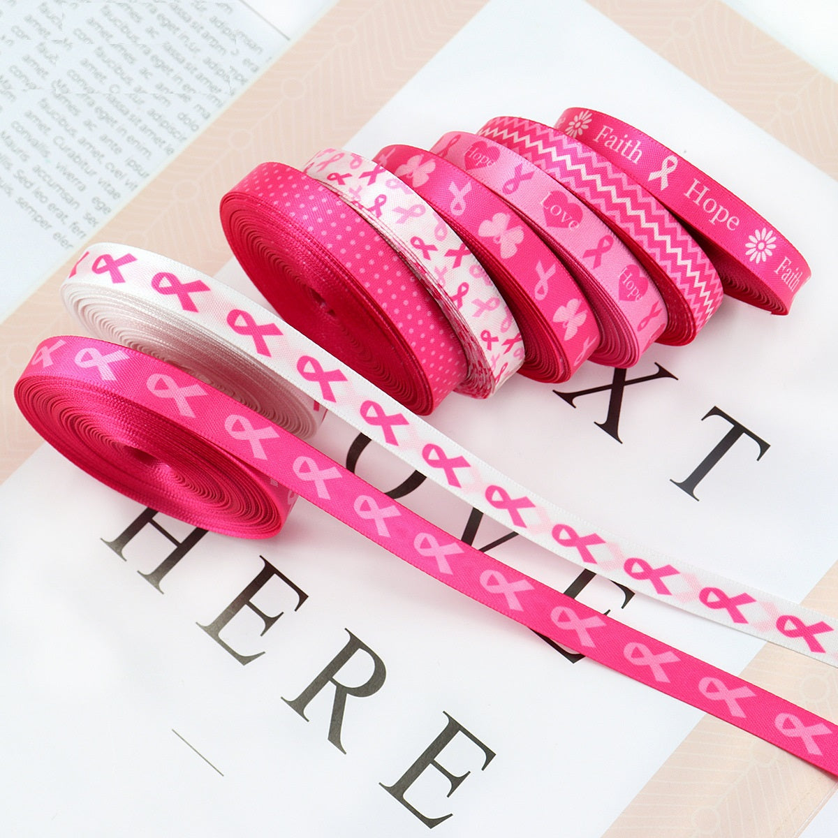 10mm ribbon rolls in pink and white patterns with faith/hope/love text.