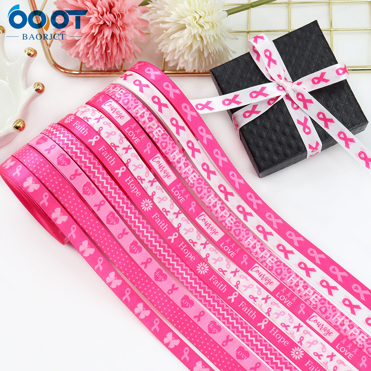 Pink 10mm ribbon with awareness symbols and text, tied around a black bow.