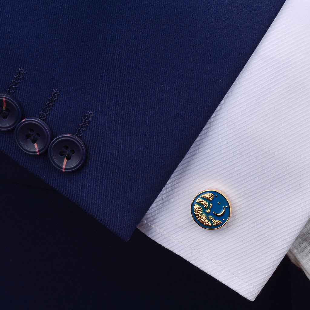 Blue moon cufflink on white dress shirt cuff, gold frame and curved moon