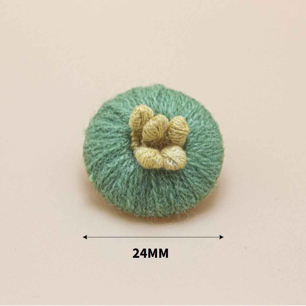 24mm knitted yarn button, green round base with yellow flower detail