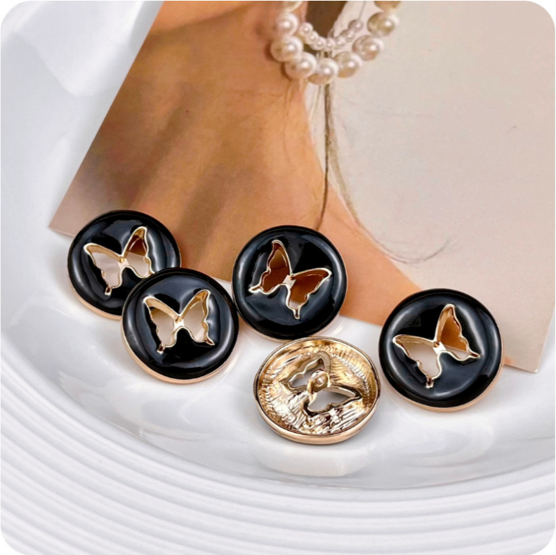 Round hollow butterfly metal buttons, black front with gold-colored butterfly cutout