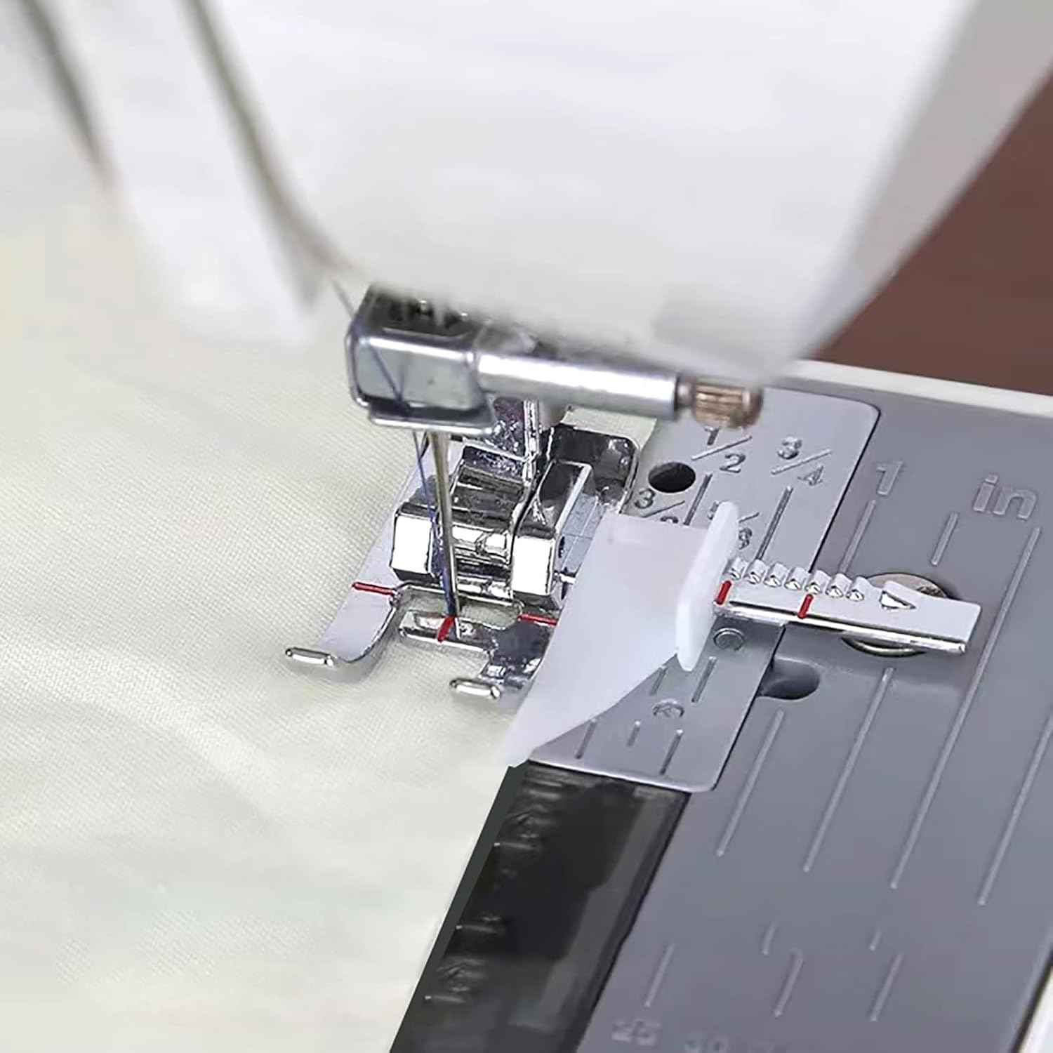 Presser foot on fabric, adjustable guide attachment with white runner and metal shank