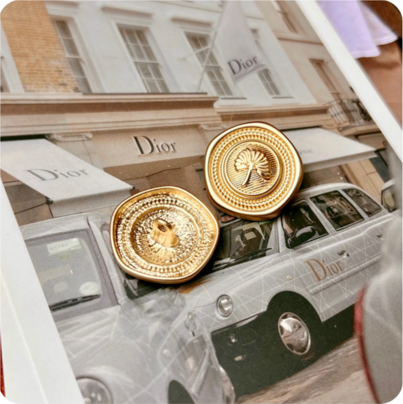 Gold pentagon metal button with apricot leaf emblem and raised ring detail