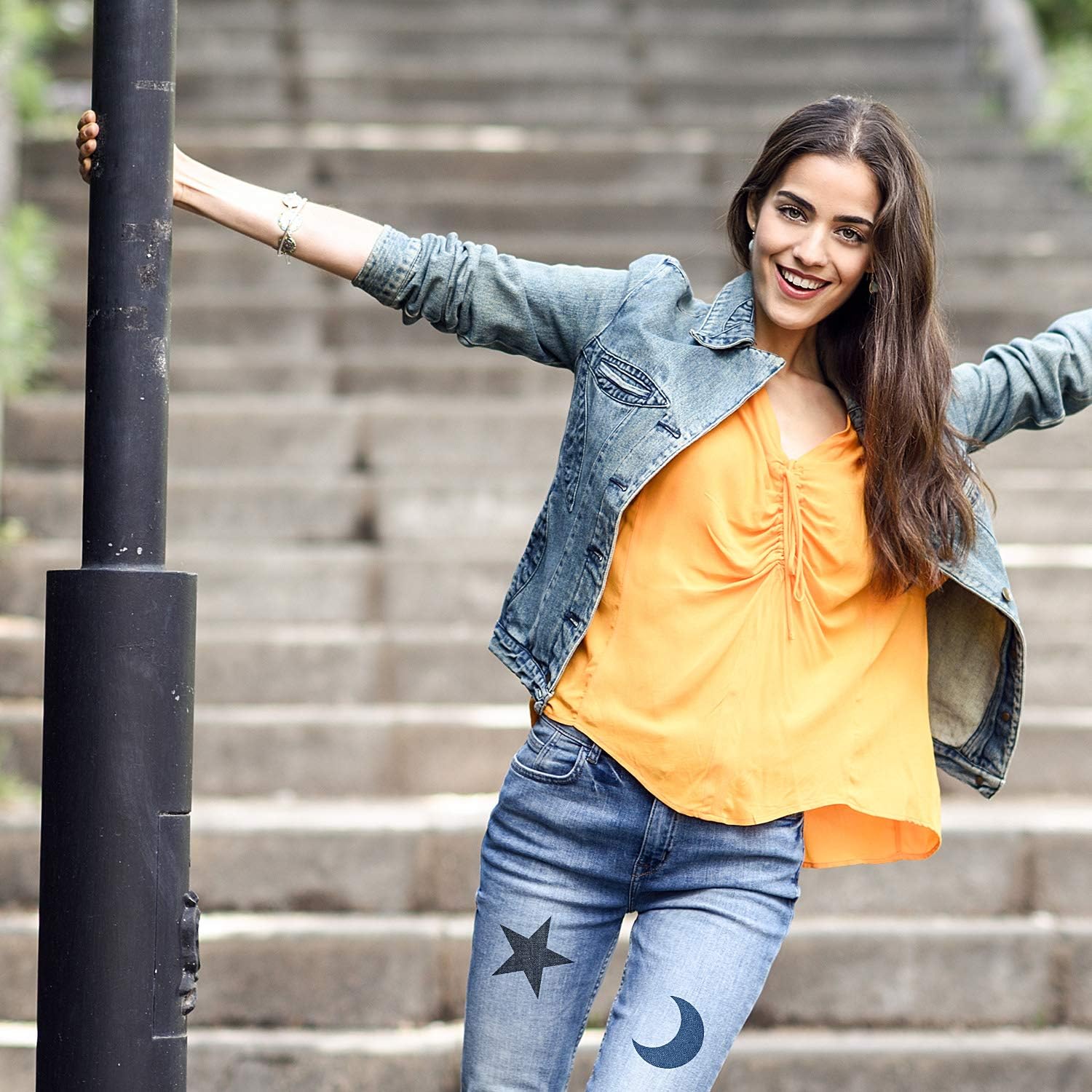Denim jacket and jeans with iron-on patches shaped like a star and a moon