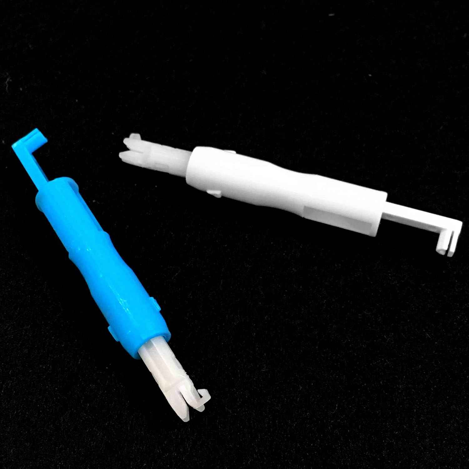 Blue and white needle threader tools with forked insertion tips.