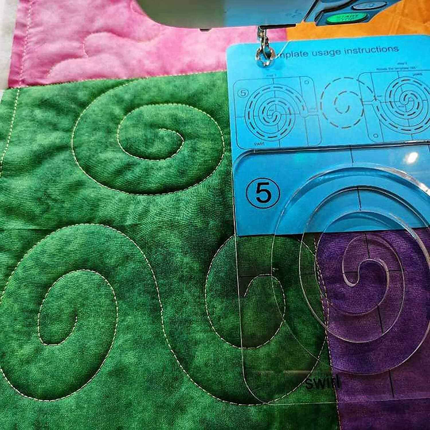 Free-motion quilting on green fabric with template guide and stitched swirl motif