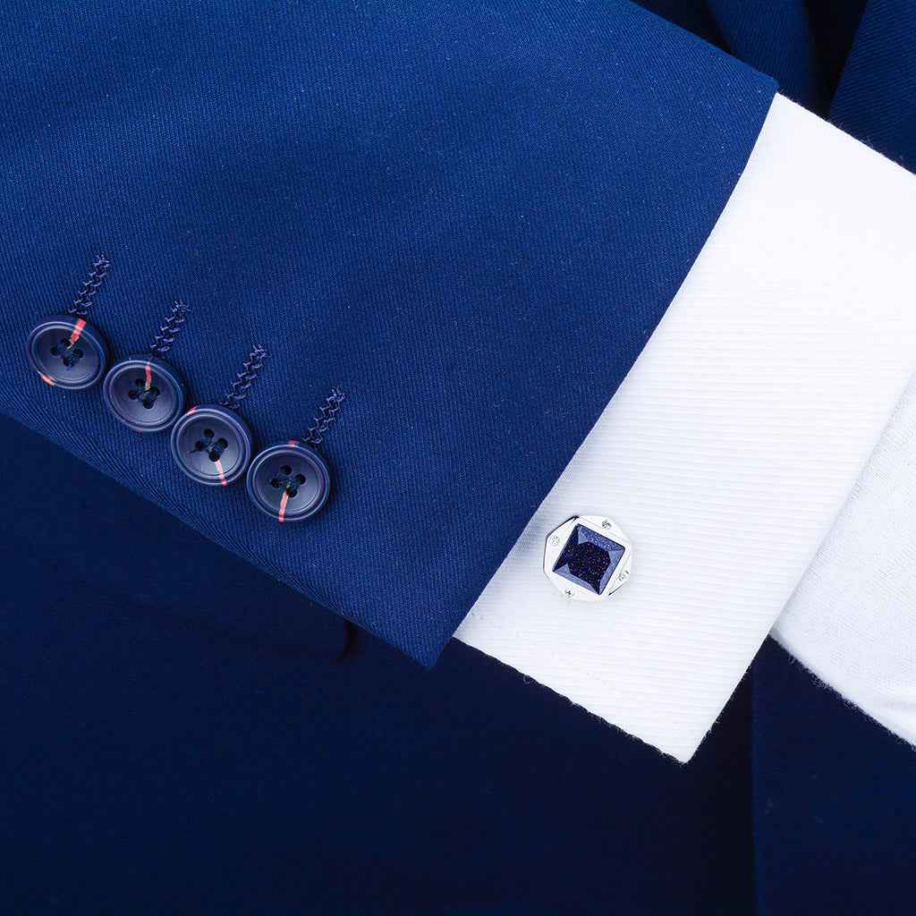 Blue gemstone square cufflinks on white shirt cuff with silver-tone setting