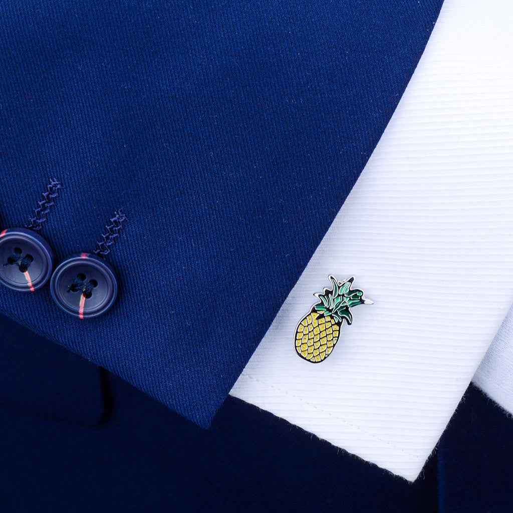 Pineapple cufflink on shirt cuff, yellow enamel body with green leaf top