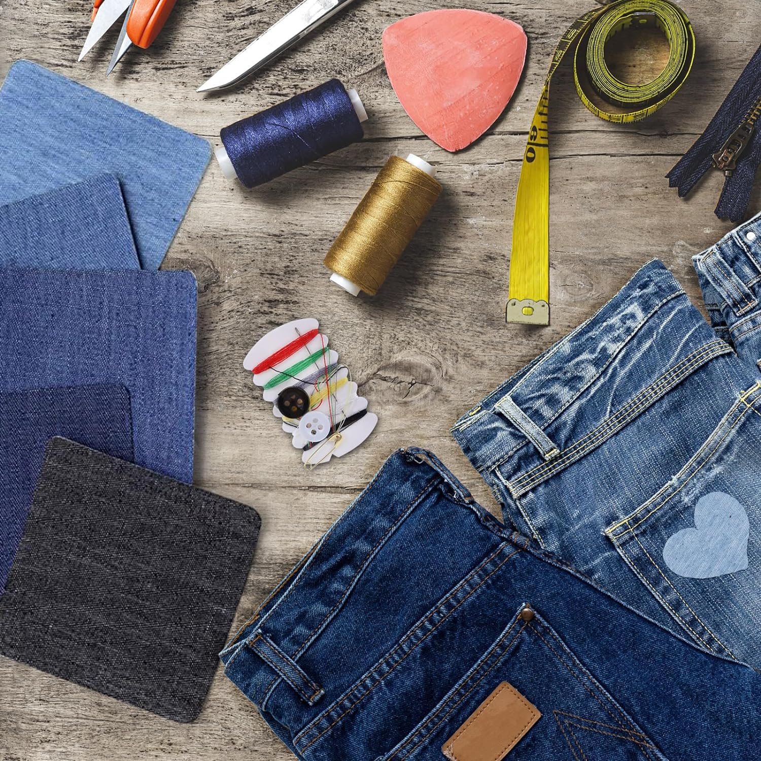Denim iron-on patches with sewing supplies and damaged jeans pieces for repair