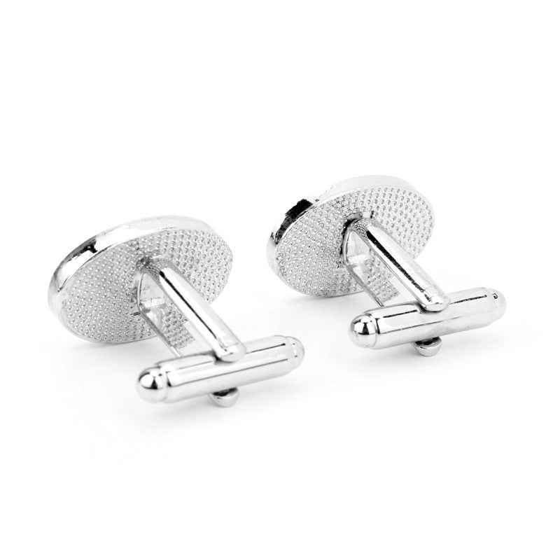 Silver “Groom” cufflinks, textured oval backs with hinged bar clasps