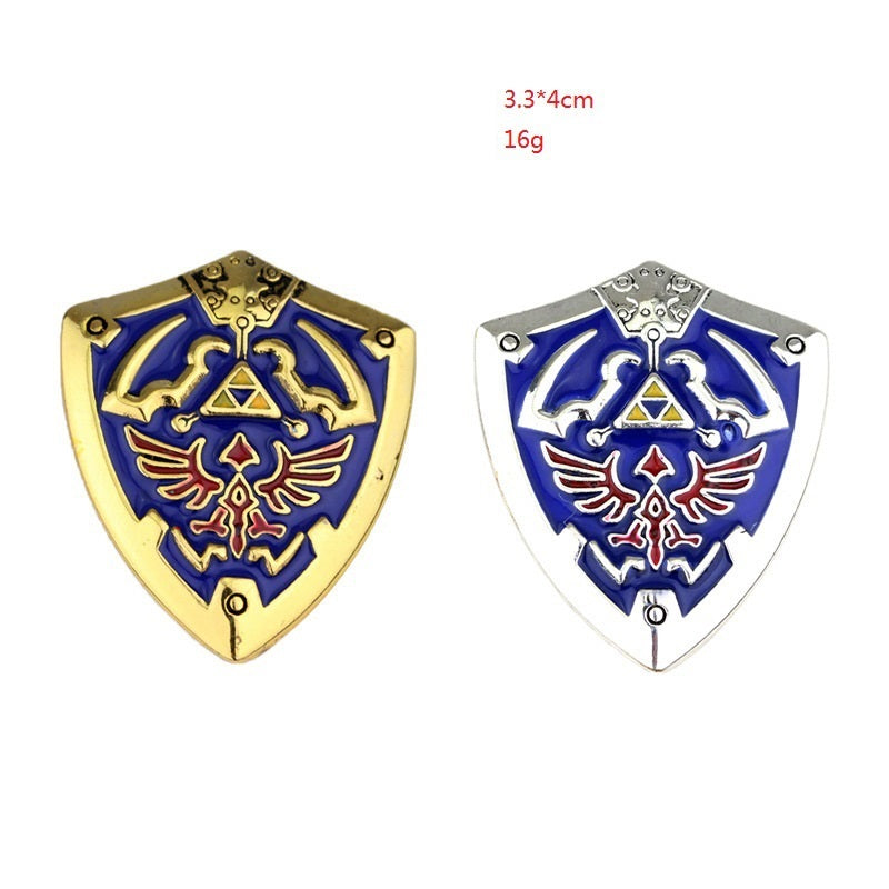 Zwei Schild-Anstecknadeln: goldfarbenes blaues Emblem und silberfarbenes blaues Emblem