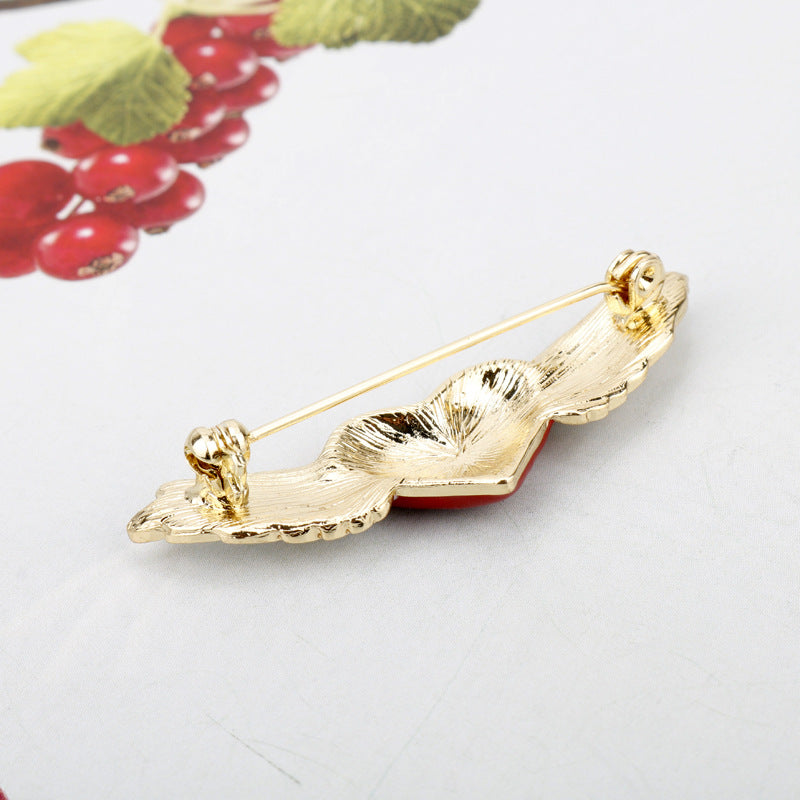 Gold-tone brooch pin back with clasp posts on a winged heart design