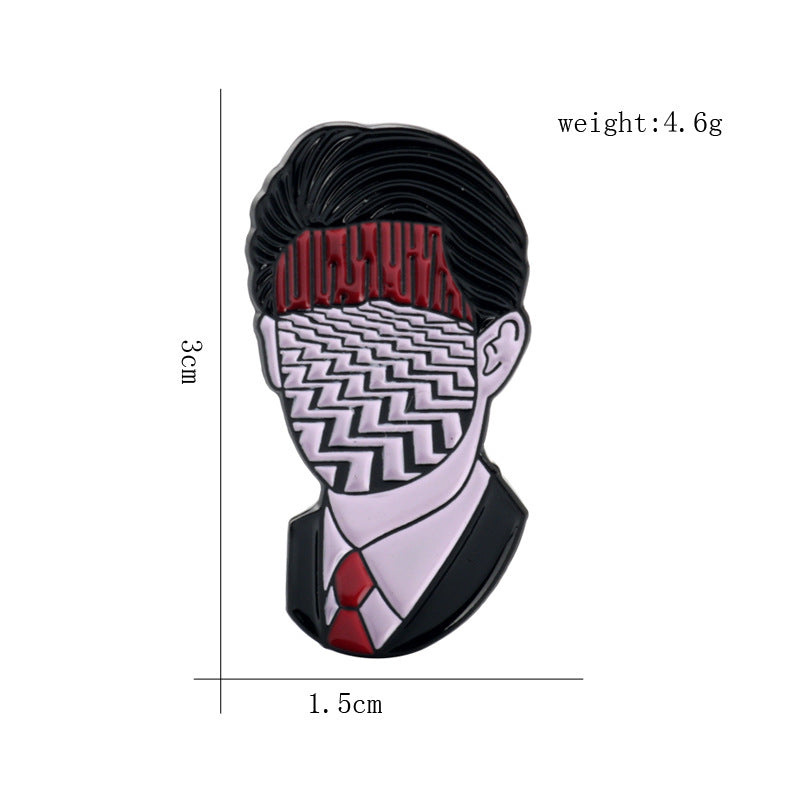 Enamel portrait pin with dark hair, red band, and white zigzag face design, black border.