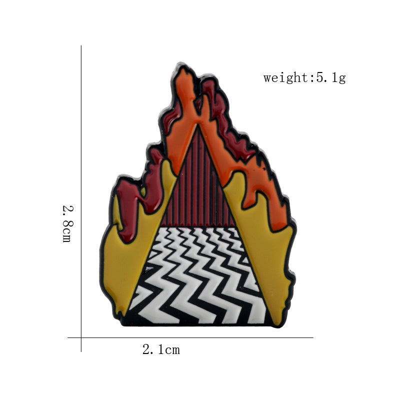 Enamel building-style pin with orange roof flames, yellow sides, and white zigzag base.