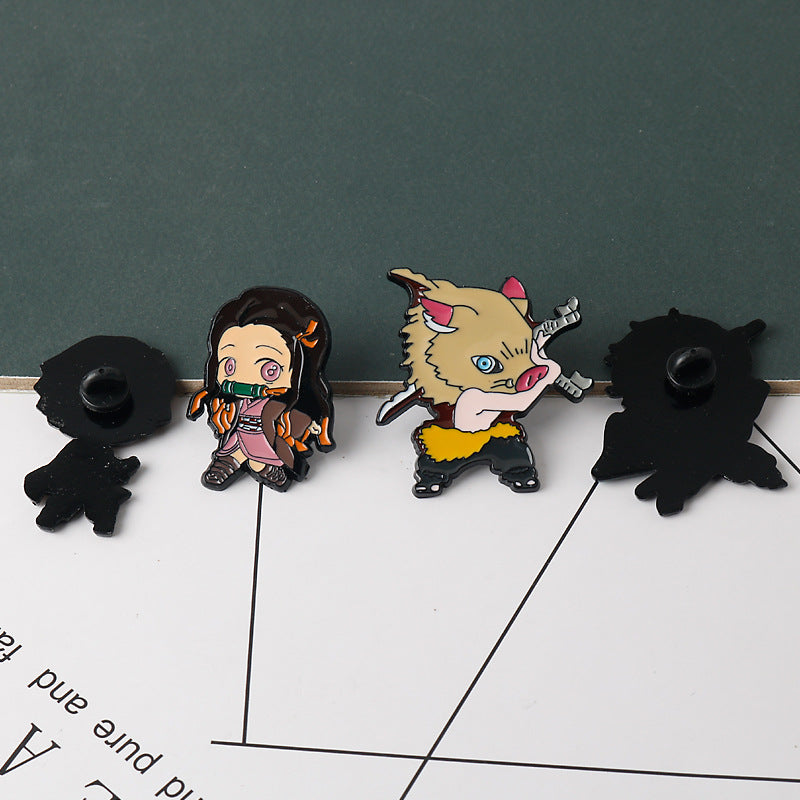 Metal brooch pins on display: dark-haired girl with green scarf and animal head character