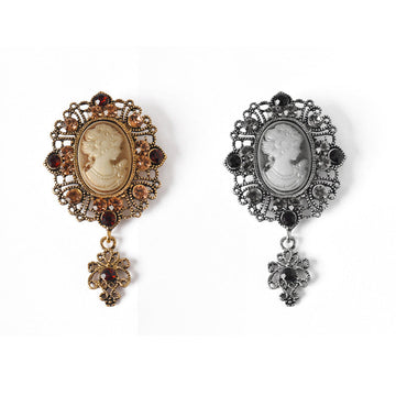 Pair of queen cameo rhinestone brooches, gold and silver with dangling cross charms