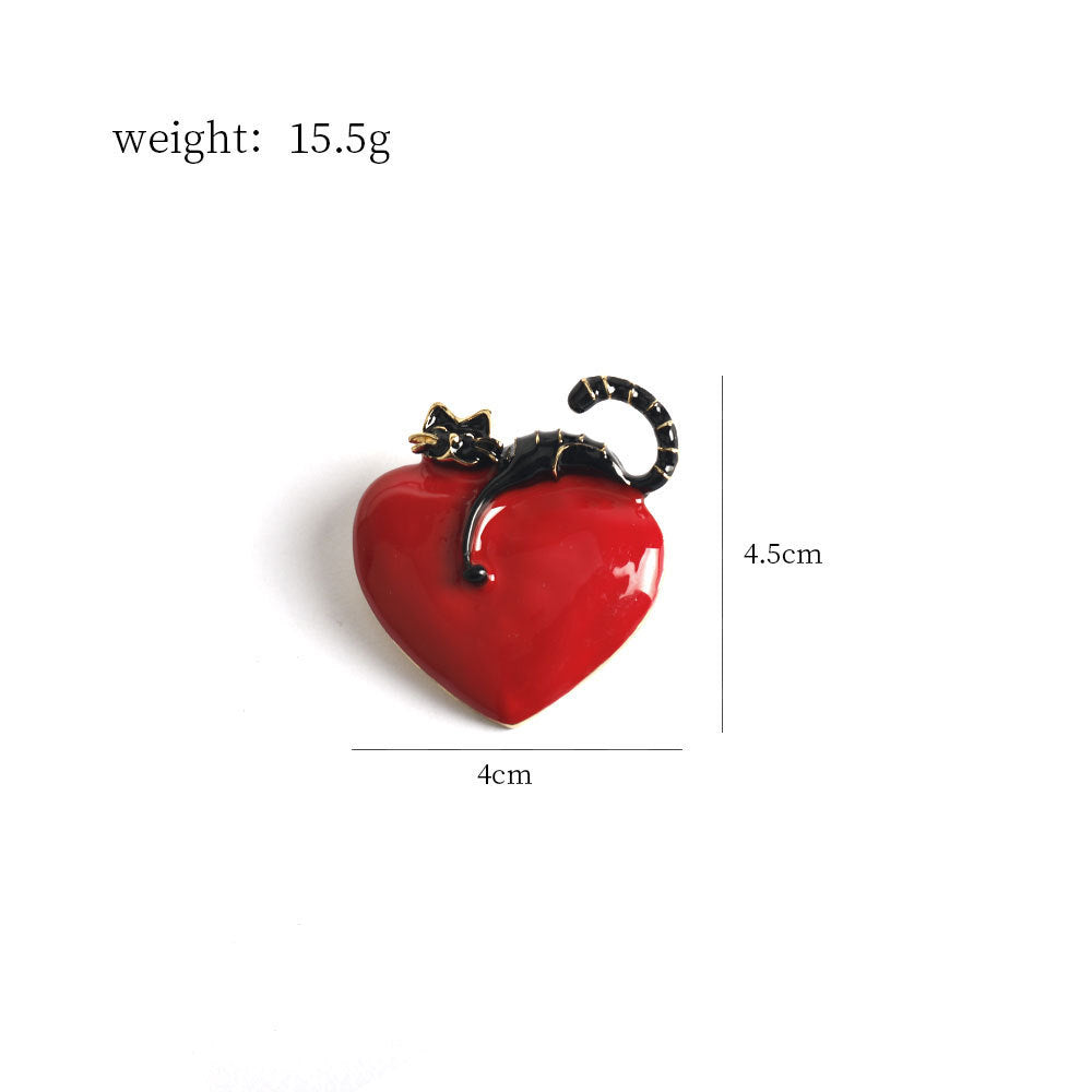 Red enamel heart kitty cat brooch with black-and-gold polka dot tail, 4cm wide