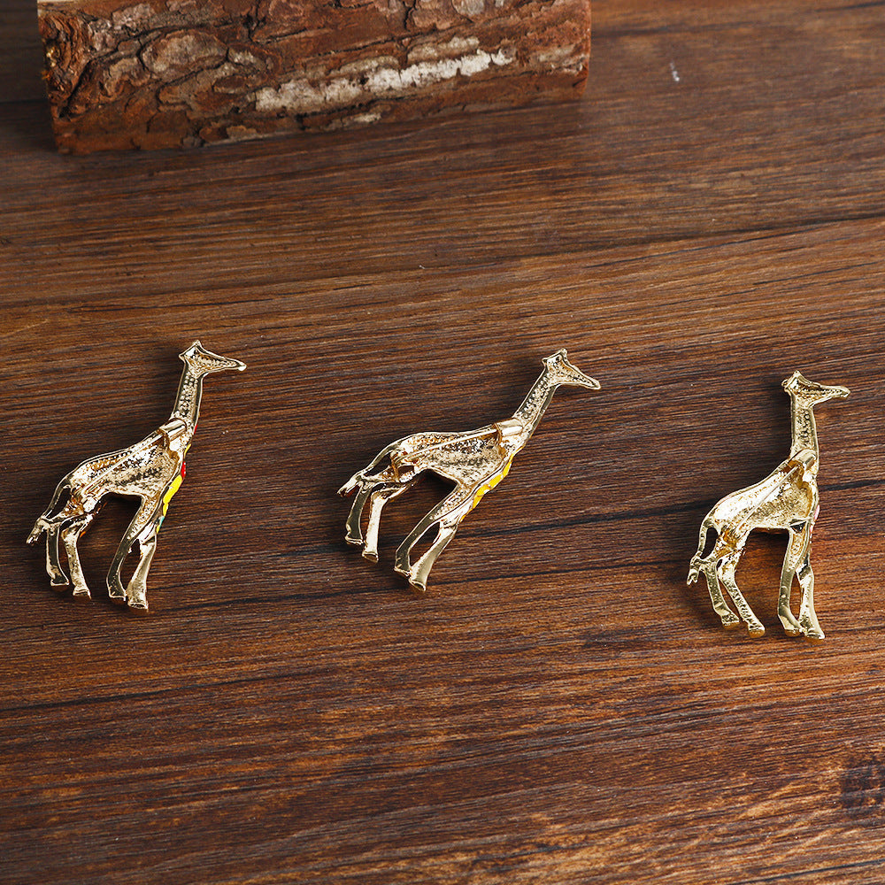 Three giraffe alloy brooch pins, gold-tone with colorful enamel