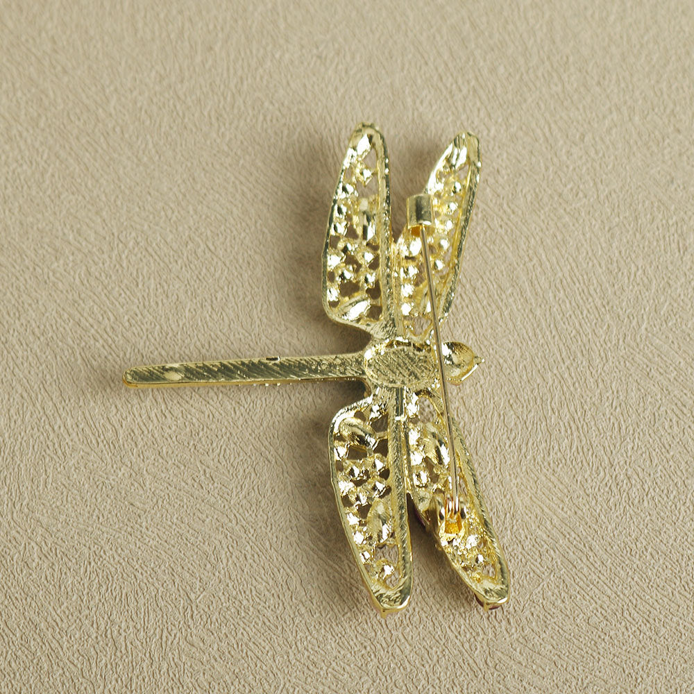 Gold-tone dragonfly brooch pin with glittering crystal wings and clasp back