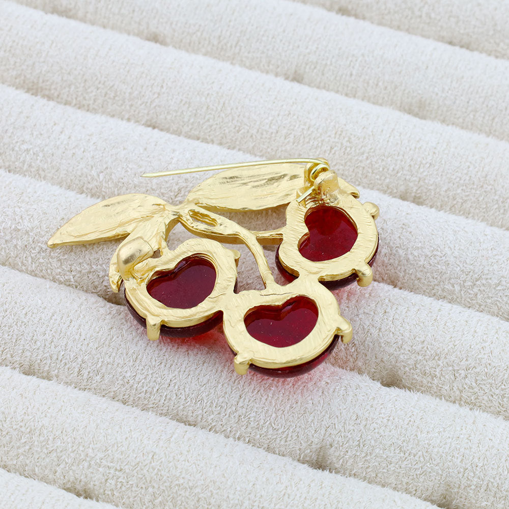 Two-piece cherry brooch pin with gold leaves, three red jelly cherries on pin posts