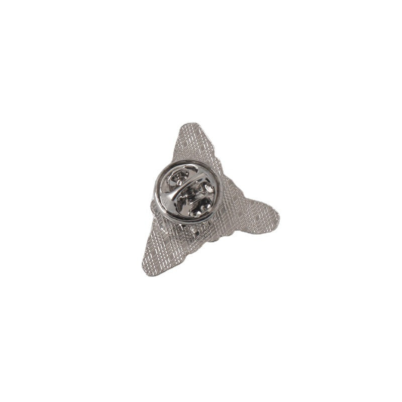 Pin badge back view with metal clasp and textured backing