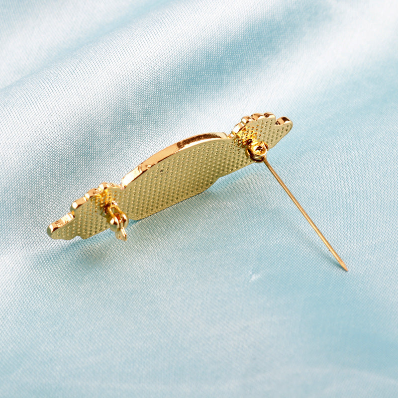 Metal brooch back view with clasp and pin needle