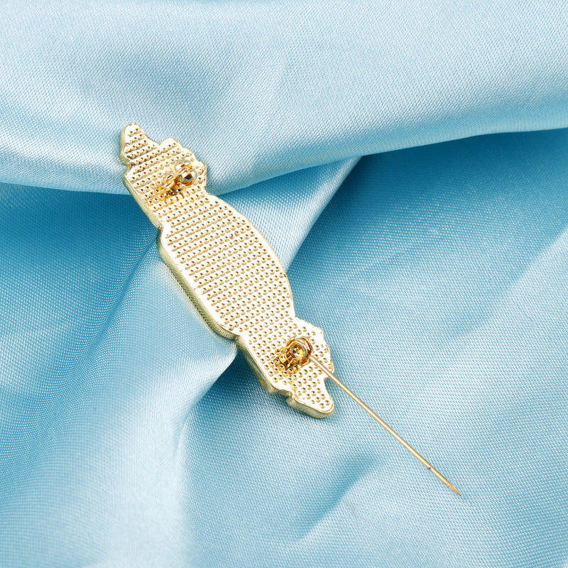 Gold-tone metal brooch pin with textured backing and straight needle