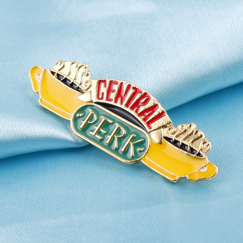 Metal enamel brooch with Central Perk sign and mugs, yellow green red details