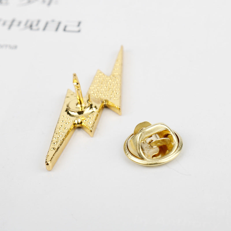 Yellow enamel lightning bolt metal pin with butterfly clasp, back visible